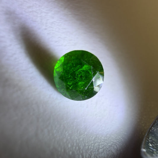 Close-up of a green gemstone on a white background