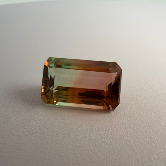 Rectangular brown gemstone on a light gray background