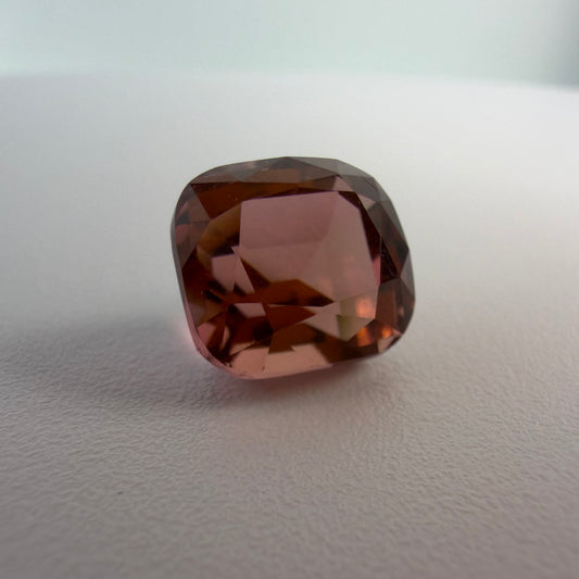 Brown gemstone on a light gray background
