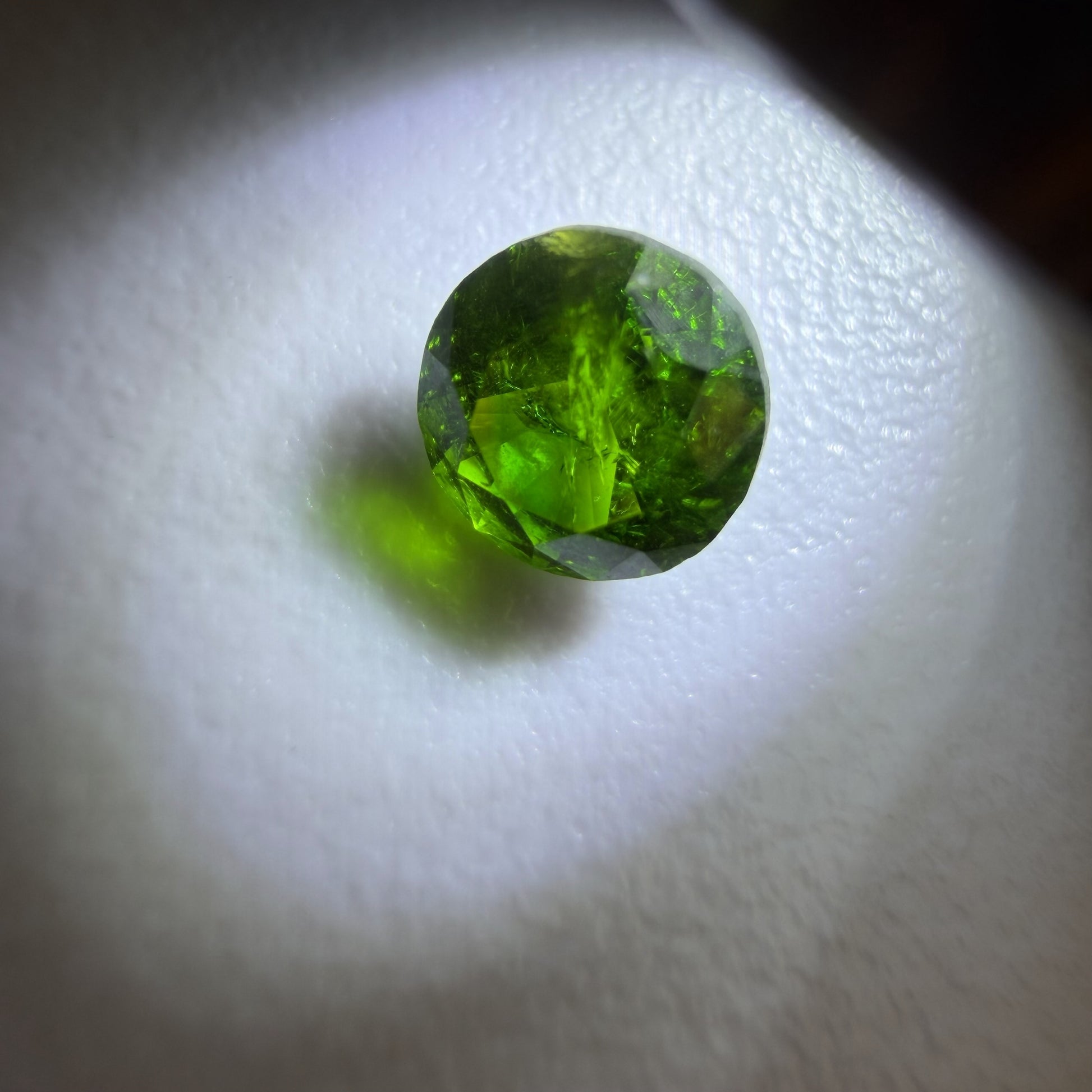 Green gemstone on a white background