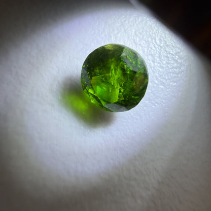 Green gemstone on a white background