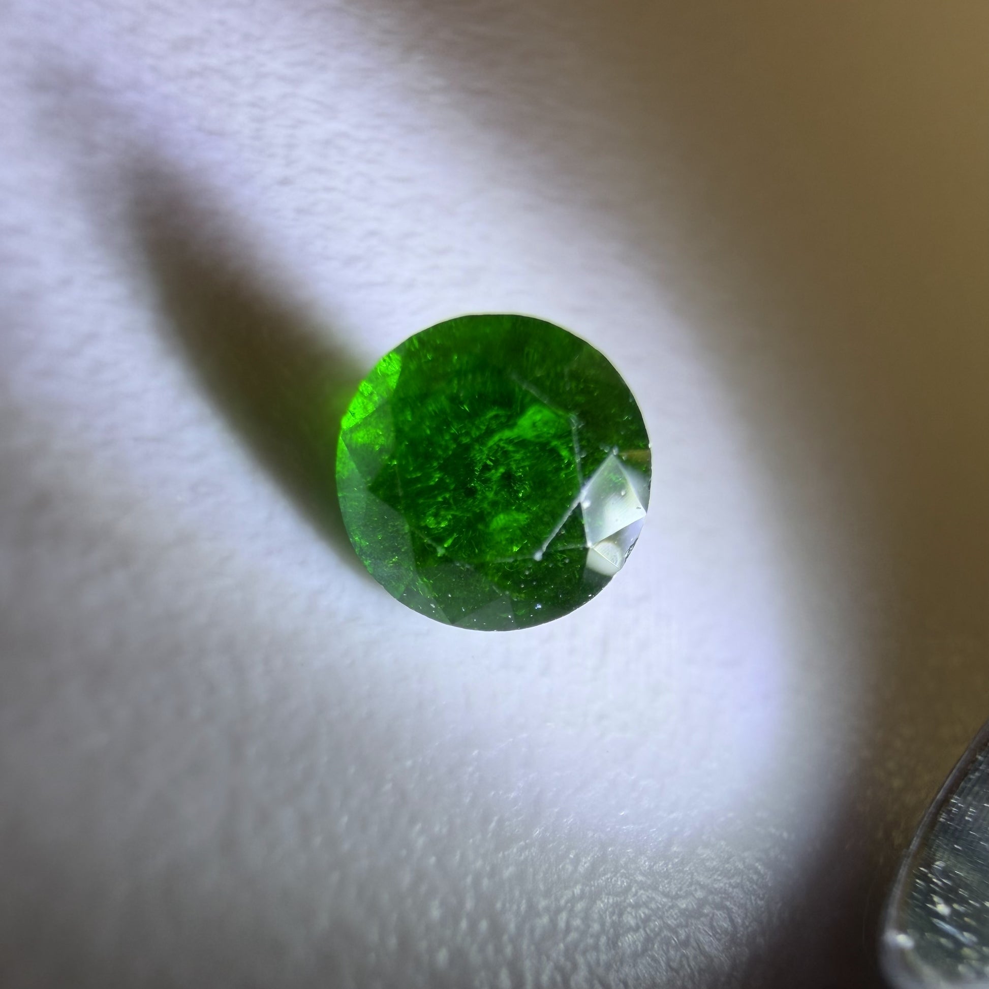 Close-up of a green gemstone on a white background