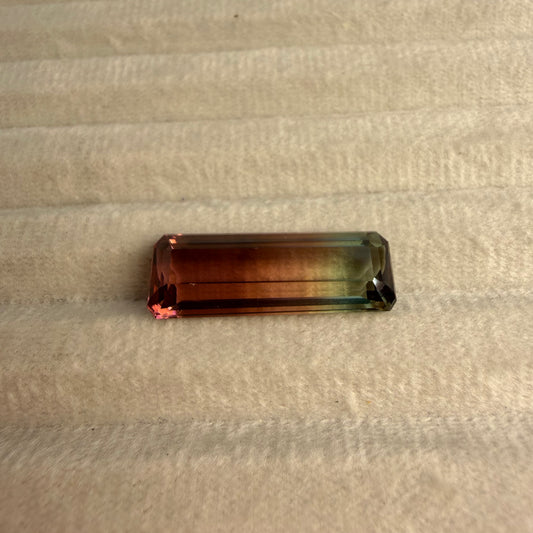 Rectangular gemstone on a beige fabric background