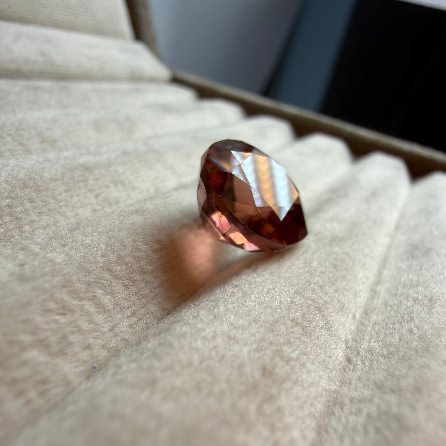 Brown gemstone on a textured surface