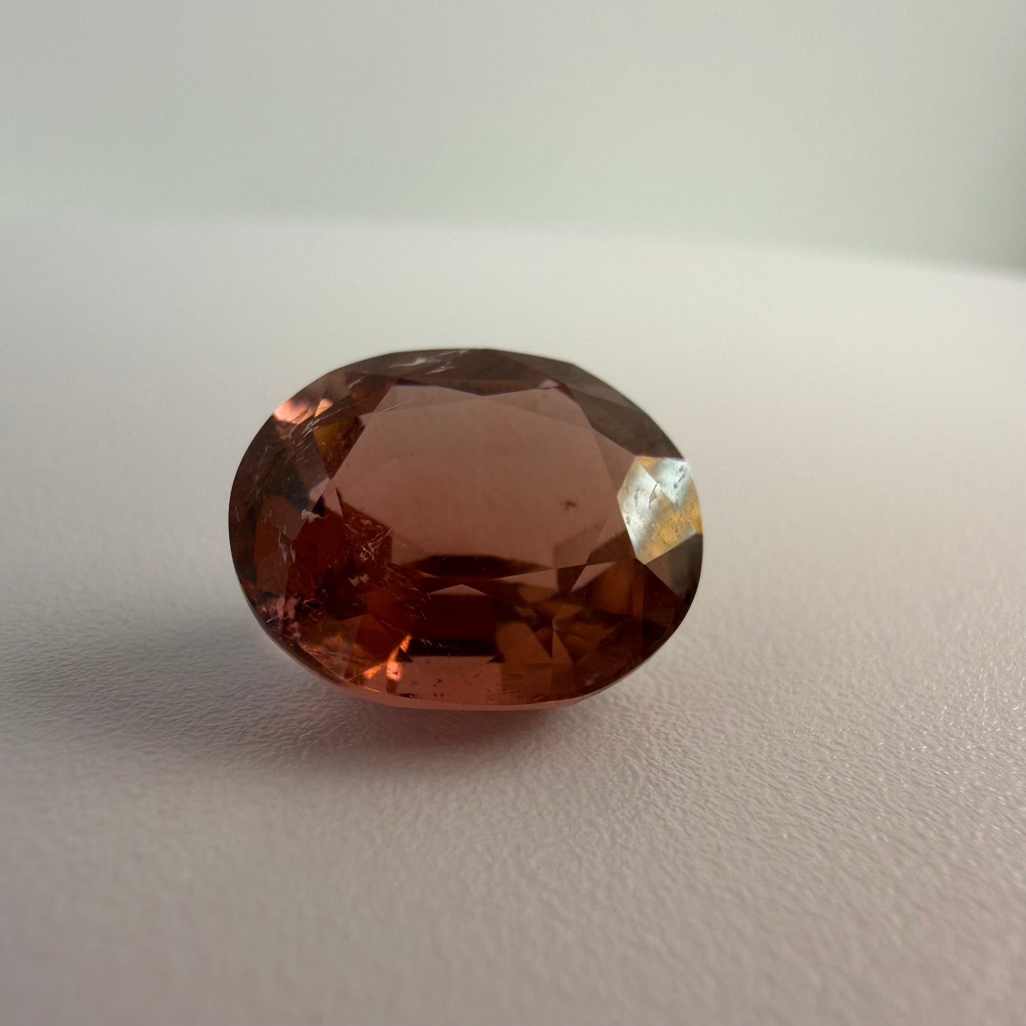 Brown gemstone on a light gray background