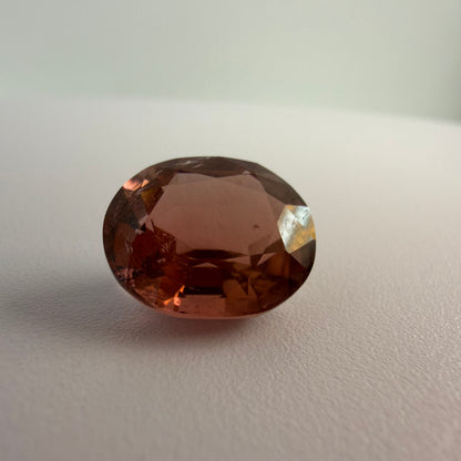 Brown gemstone on a light gray background