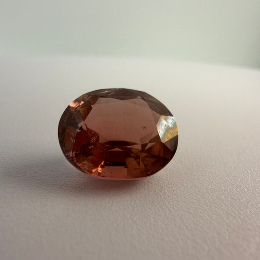 Brown gemstone on a light gray background