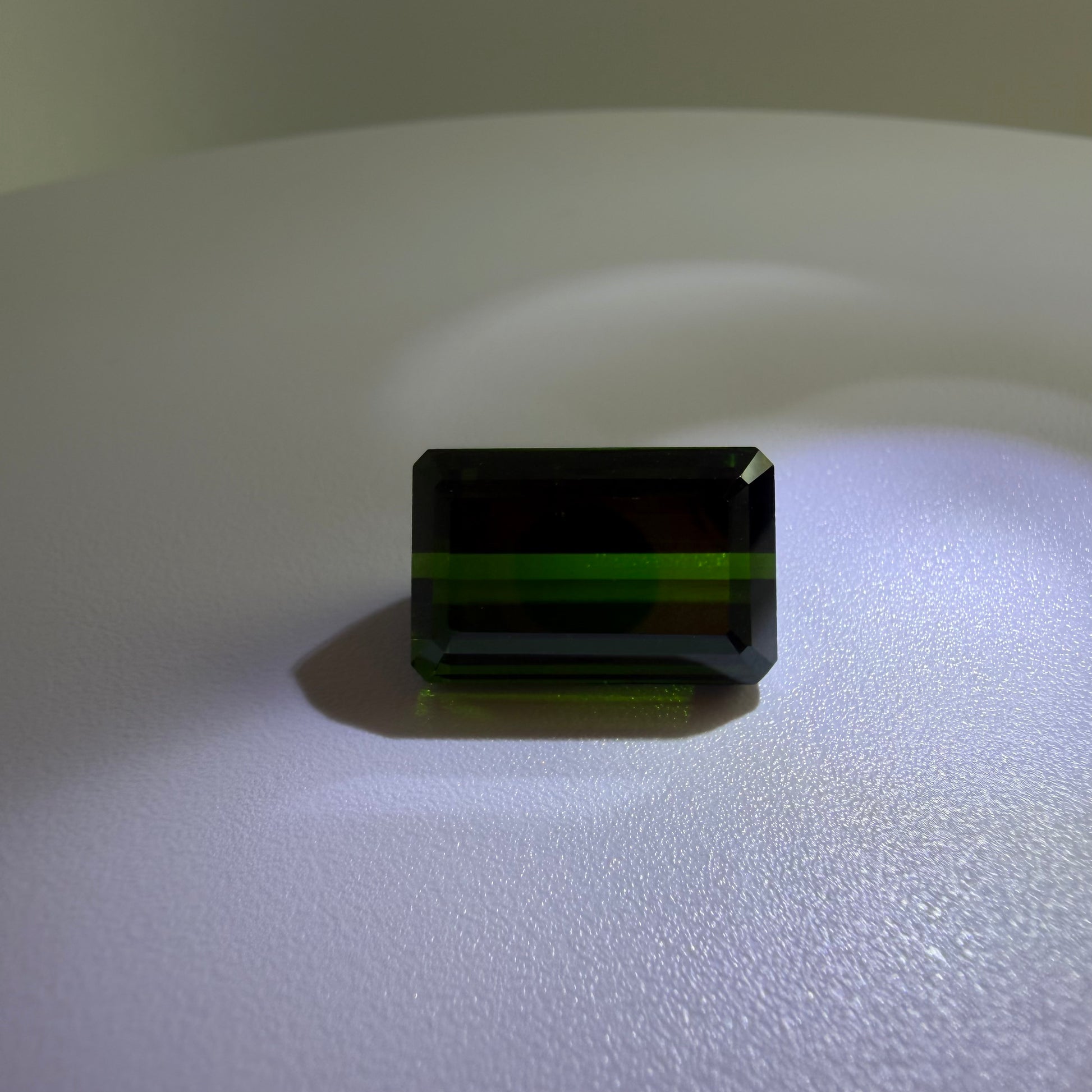 Rectangular green gemstone on a white background