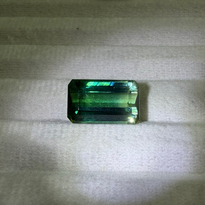 Green gemstone on a textured gray background