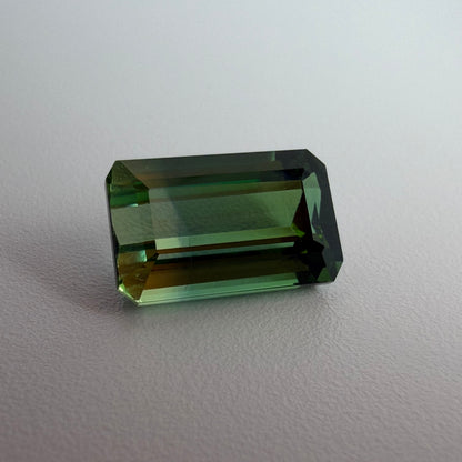 Green gemstone on a light gray background