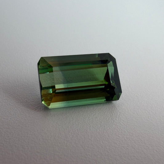 Green gemstone on a light gray background