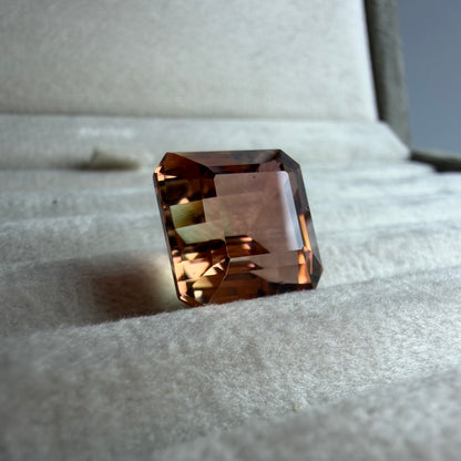 Brown gemstone on a textured surface