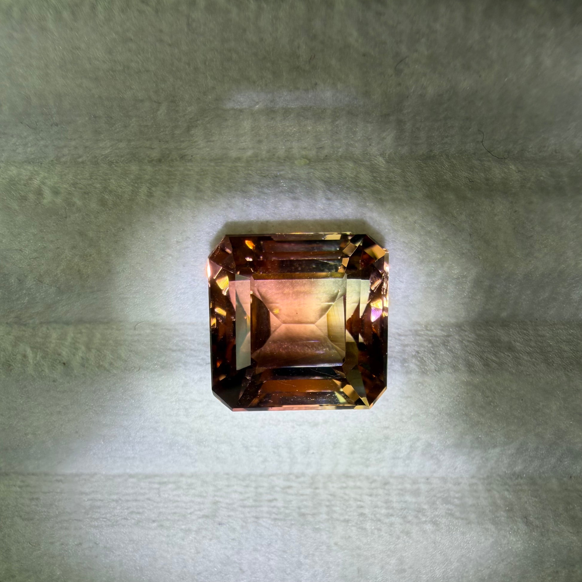 Rectangular gemstone on a textured gray background