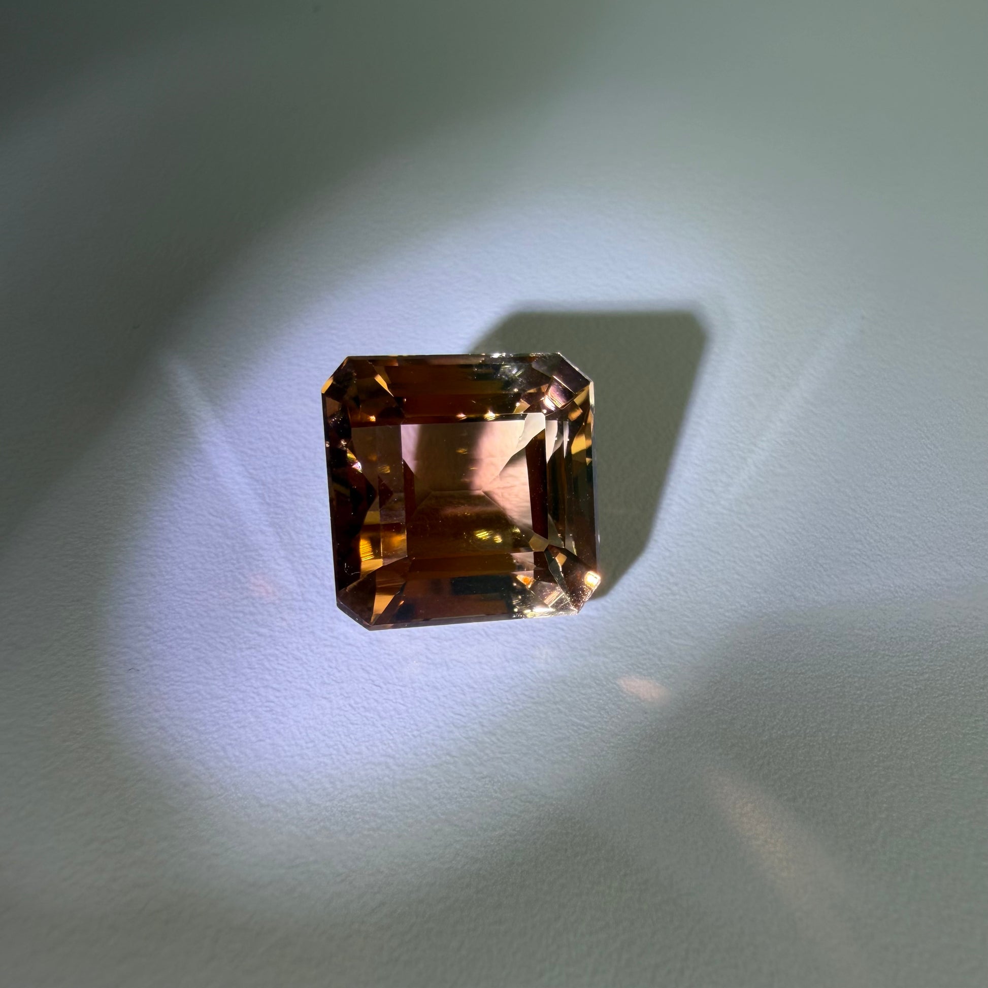 Rectangular brown gemstone on a light gray background