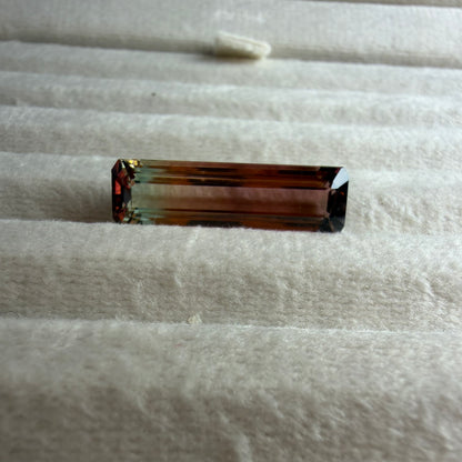 Rectangular gemstone on a textured white surface