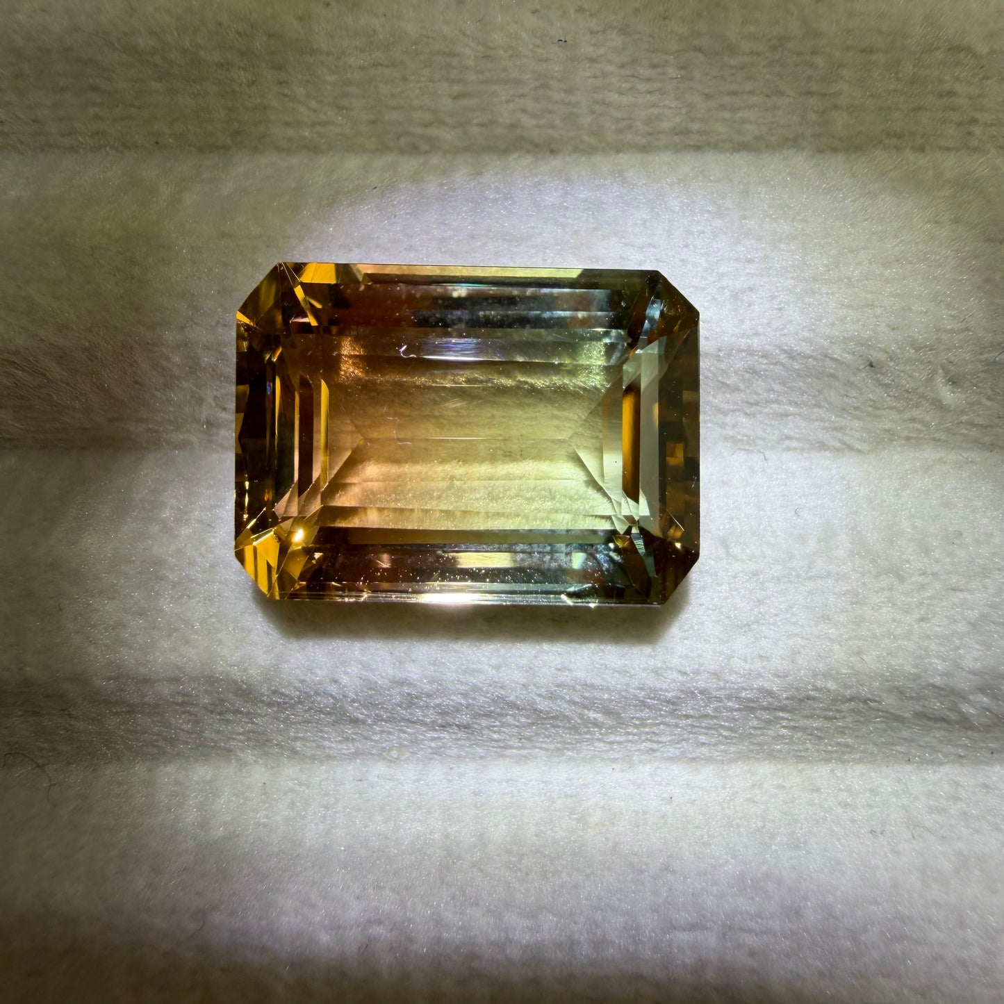 Rectangular gemstone on a textured gray background