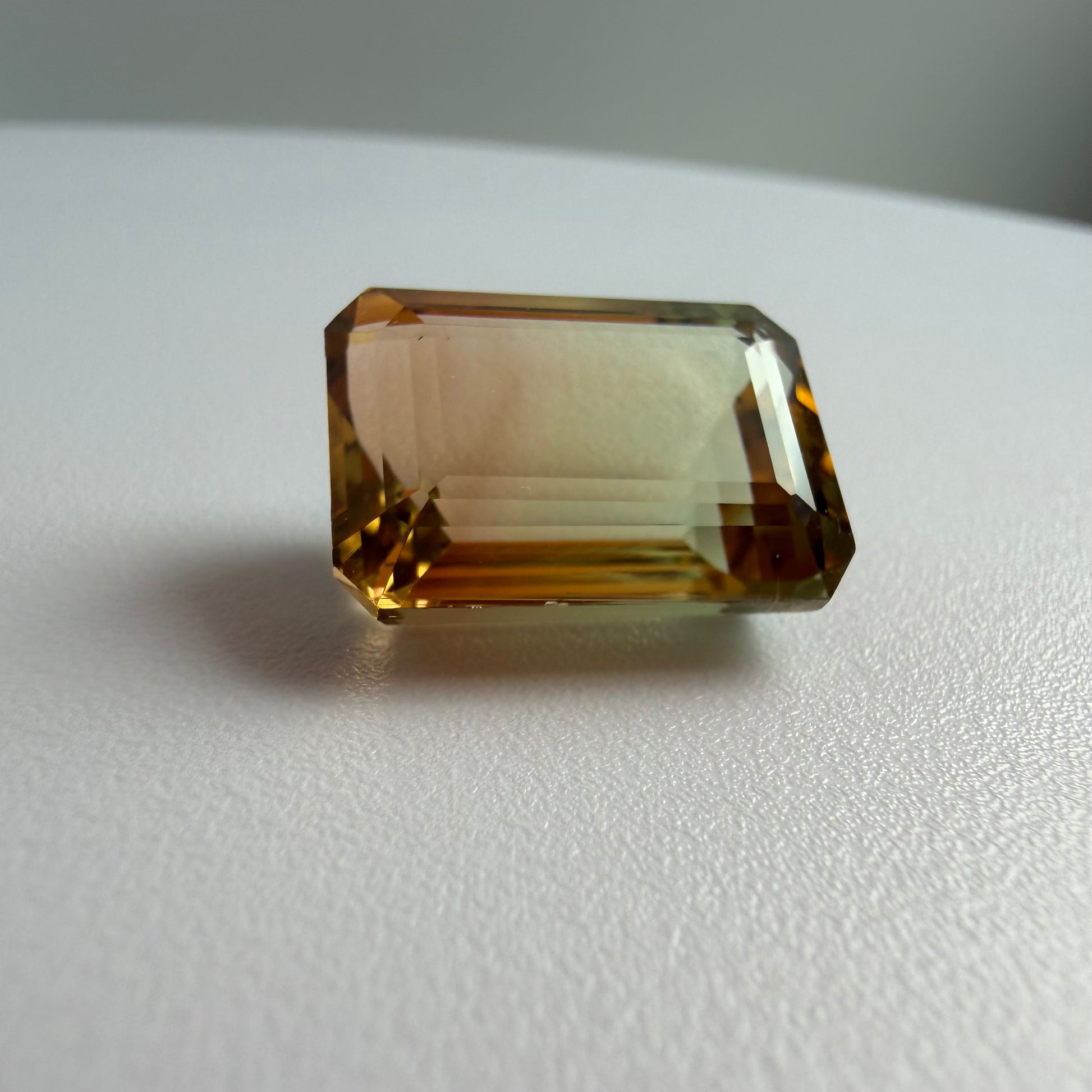 Rectangular brown gemstone on a white surface